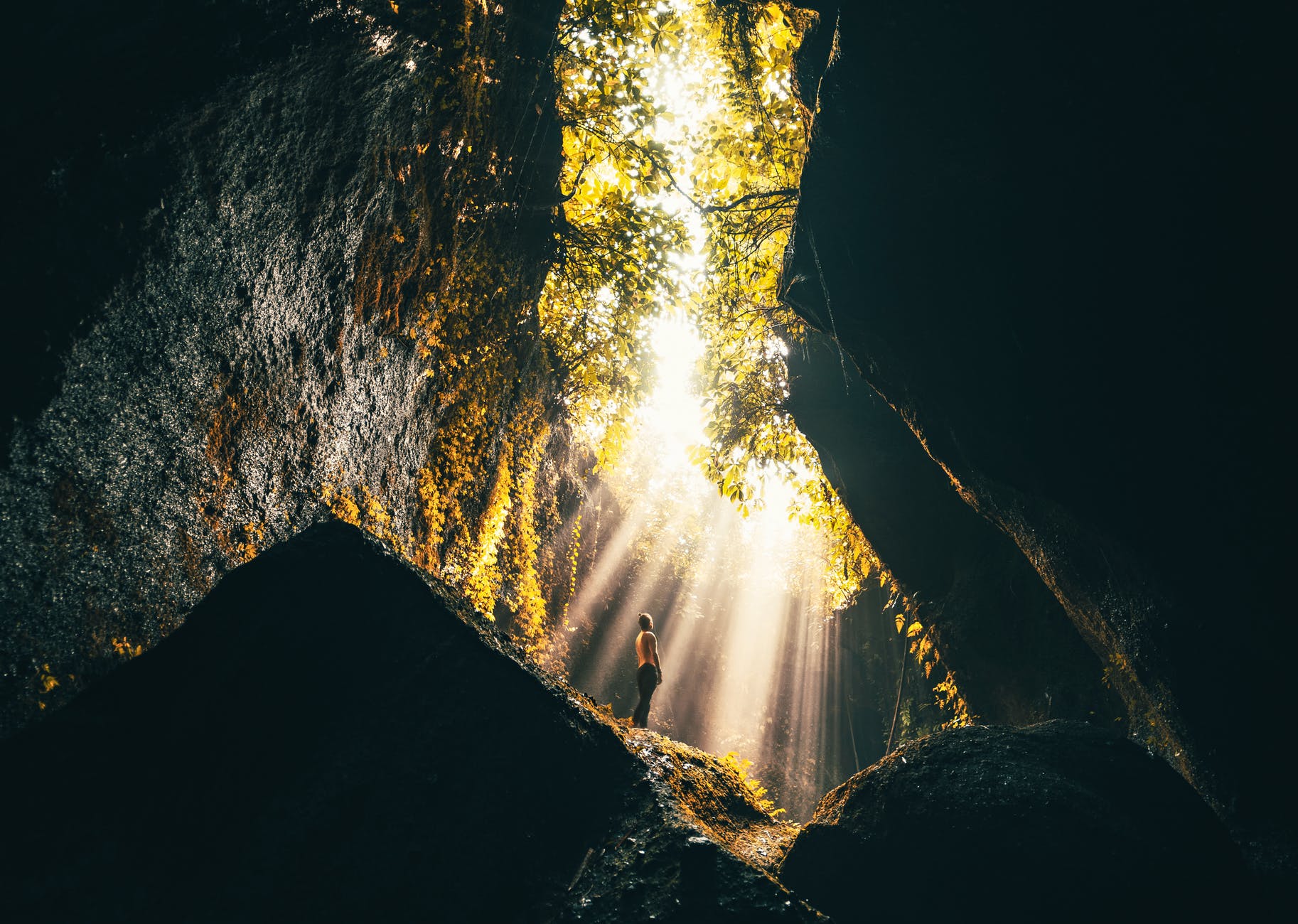 photo of person standing on rocks